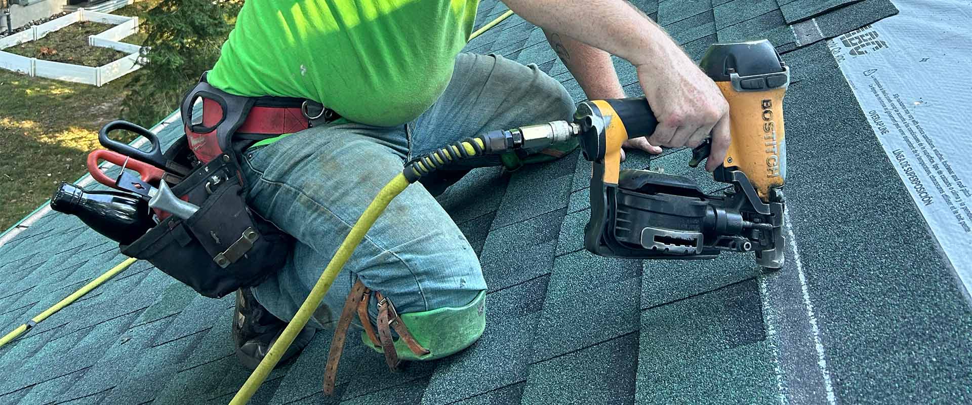 Professional roofing contractor installing asphalt shingles on residential roof in Ottawa
