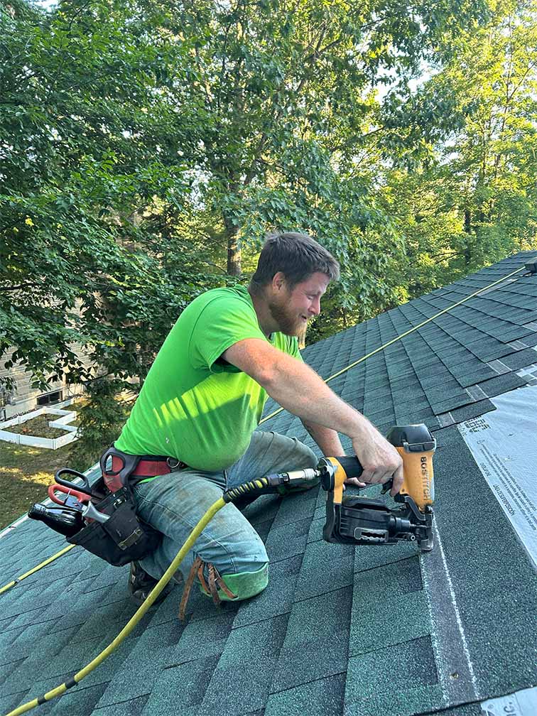 Professional roofing contractor installing asphalt shingles on residential home in Ottawa