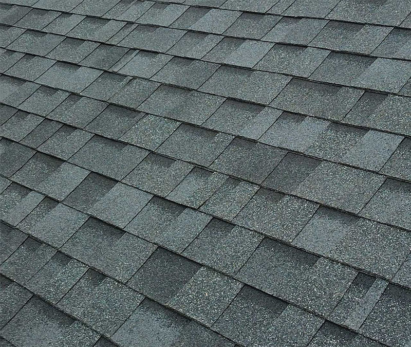 clean asphalt shingle roof surface after soft wash treatment showing restored shingles and no algae